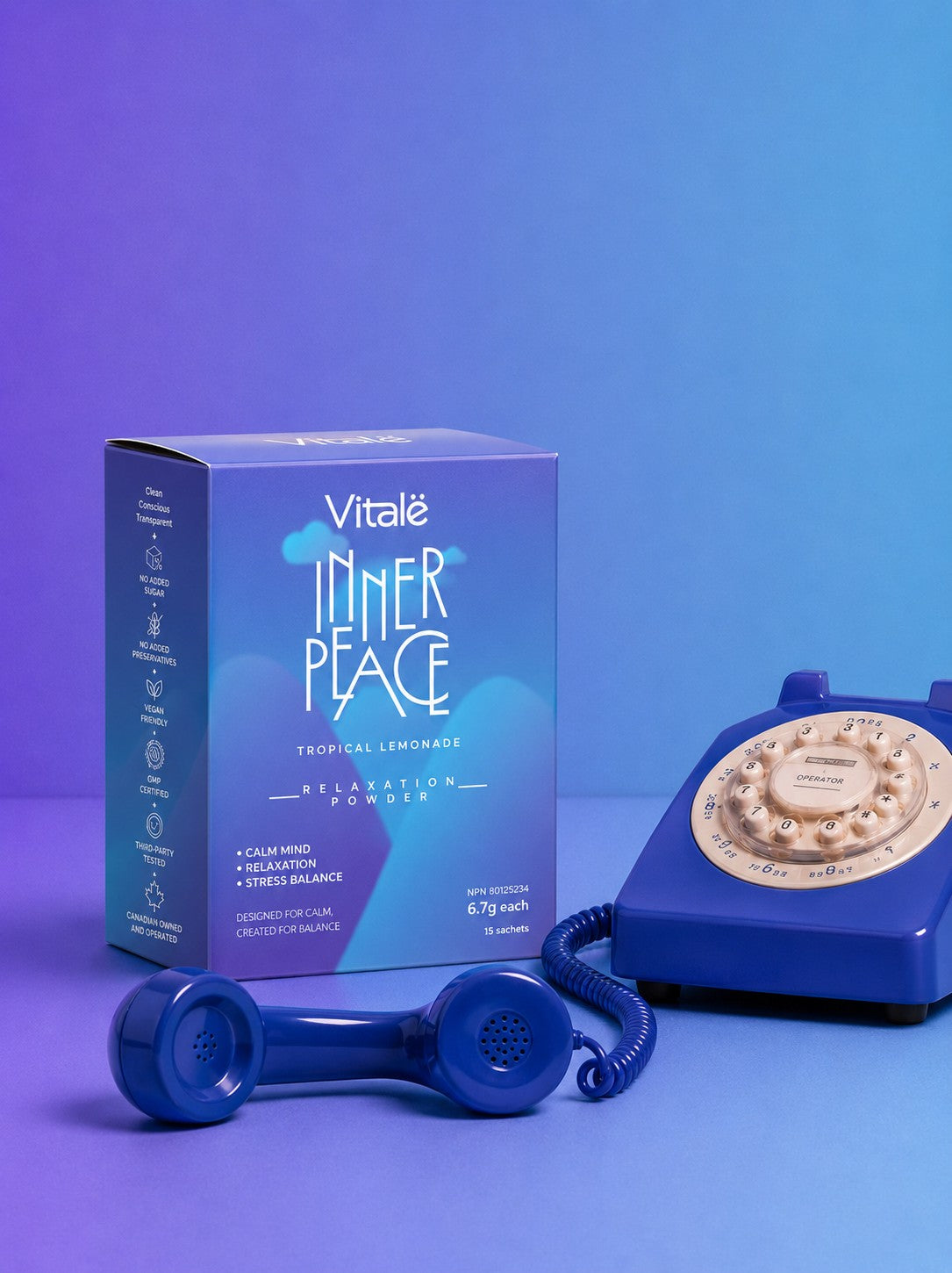 Vitalë Inner Peace™ tropical lemonade box beside a retro telephone on a purple and blue gradient.
